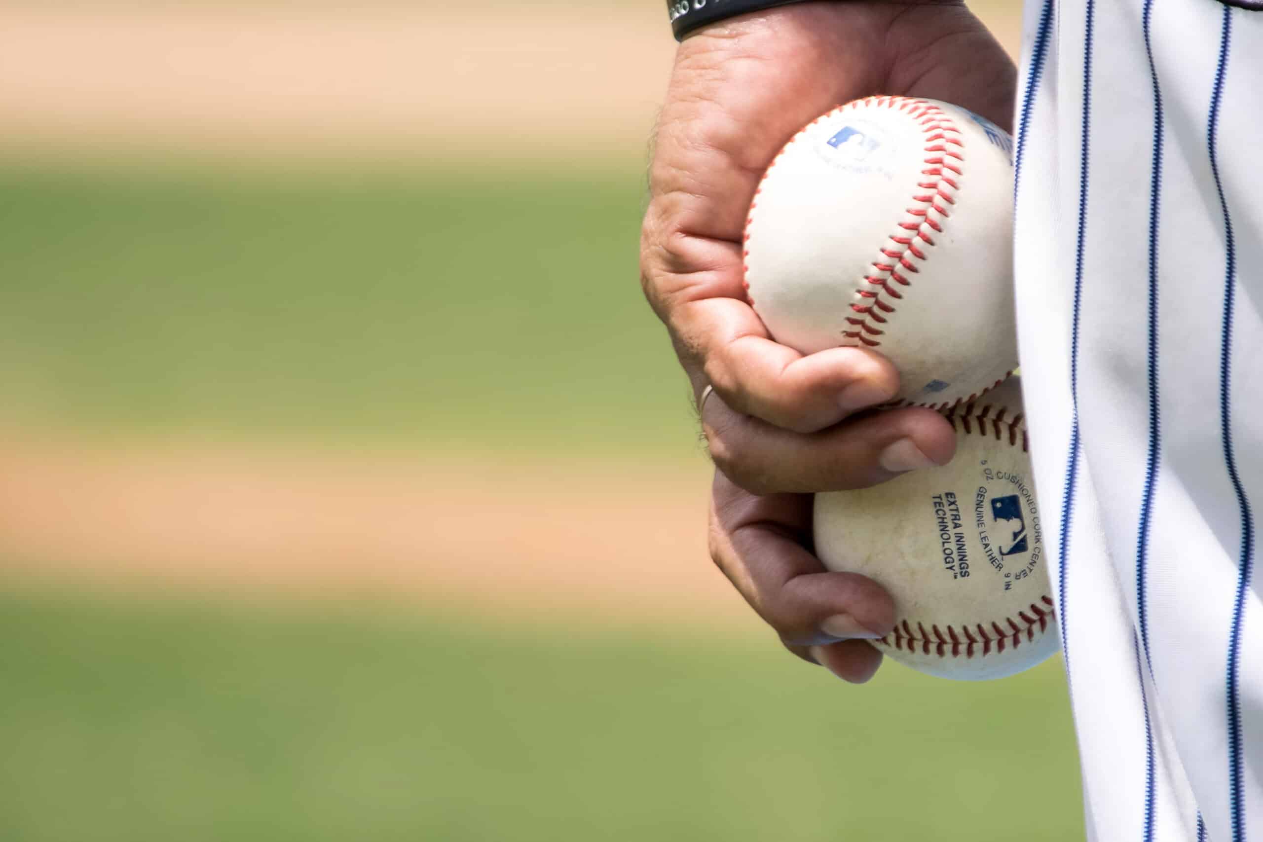 baseball players holding two baseballs, fundraising ideas, charity ideas, silent auction items, travel fundraising events