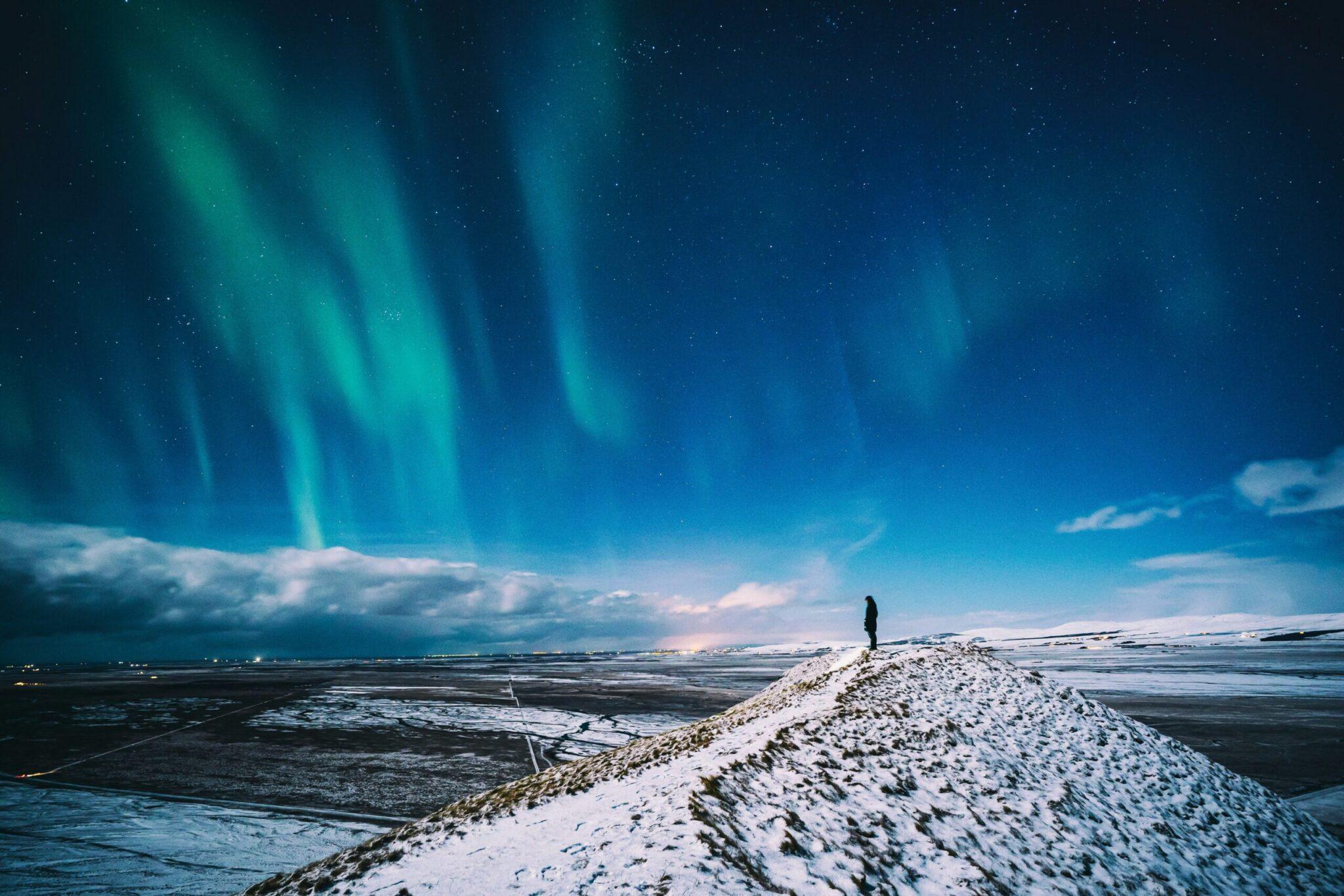 person standing on snowy mountain, charity auction travel packages, vacation fundraising, travel fundraising, fundraising ideas, charity ideas, silent auction items, travel fundraising events